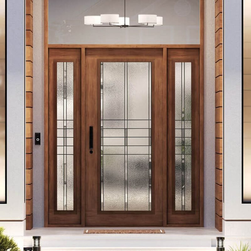 A stained wood front door with a full height panel of textured glass in a black grid, flanked by two matching glass sidelights, under a lit transom